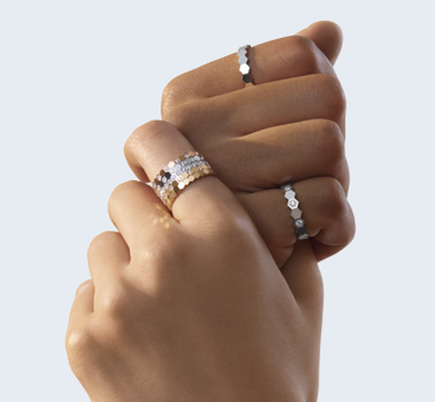 Chaumet Bee My Love rings on a white, grey background.